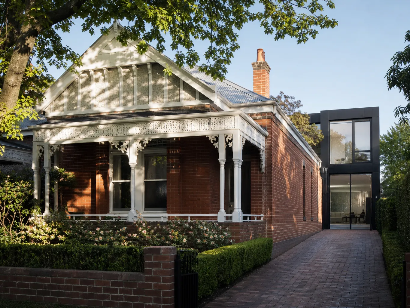 Renovated period home with a modern glazed rear extension among established gardens in Melbourne's east